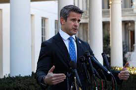 Congressman Adam Kinzinger standing outside the White House, in front of microphones, speaking to the press;