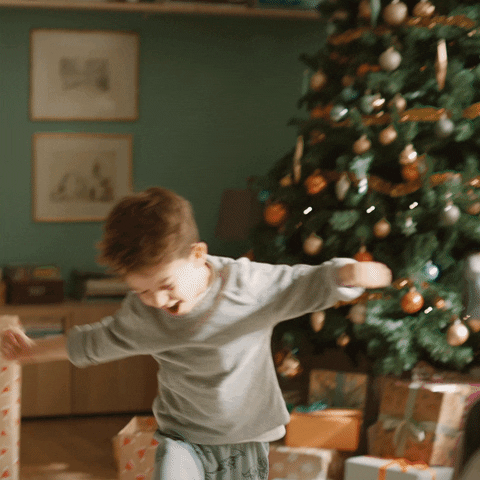 Little Boy Happy to get Christmas Presents;