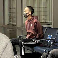 Brian Hsu unruly American Airlines passenger handcuffed and sitting in the aiport;