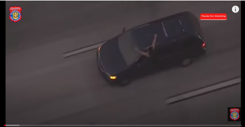 California police chasing a man, who is hanging out the window and blowing kisses at them, through Orange County and Los Angeles County;