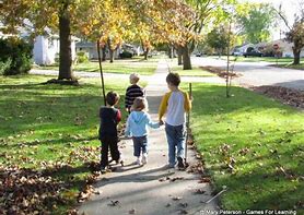 Children Walking On A Sidewalk;