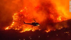 Helicopter dropping water on the El Dorado Fire area;