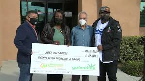 Jose (Mr. V) Villarruel receiving a $27,000 check from his former student Steven Nava's gofundme campaign;