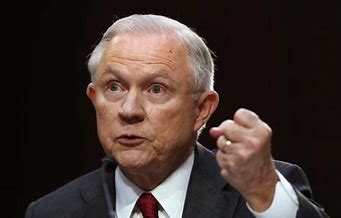 Jeff Sessions holding up a balled up fist;