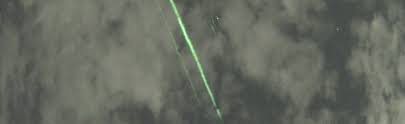 NASA green laser cruising across the night sky near Mount Fuji in Japan;