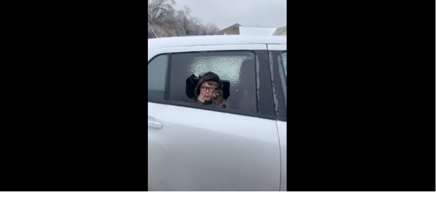 Kid gives an uh-oh look after breaking fake car window;