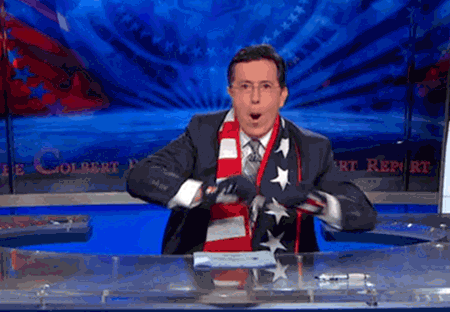 Stephen Colbert has the flag over his shoulders and painted on his hands;