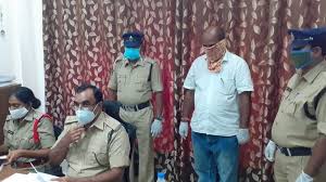 Indian Official arrested and wearing a coronavirus mask;