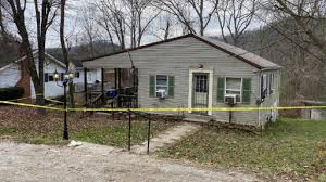 Yellow tape around the home of a West Virginia juvenile who killed four family members;