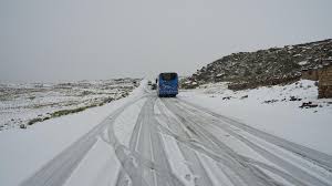 Winter storm Uri a bus on a snow covered road;