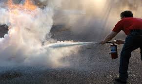Dude using a fire extinguisher;